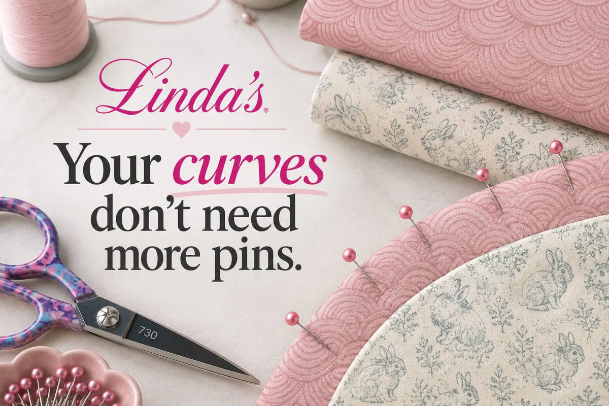 Pink and cream bunny-print curved quilt pieces pinned with pink-headed pins beside floral scissors and pink thread, with the words Your curves don't need more pins