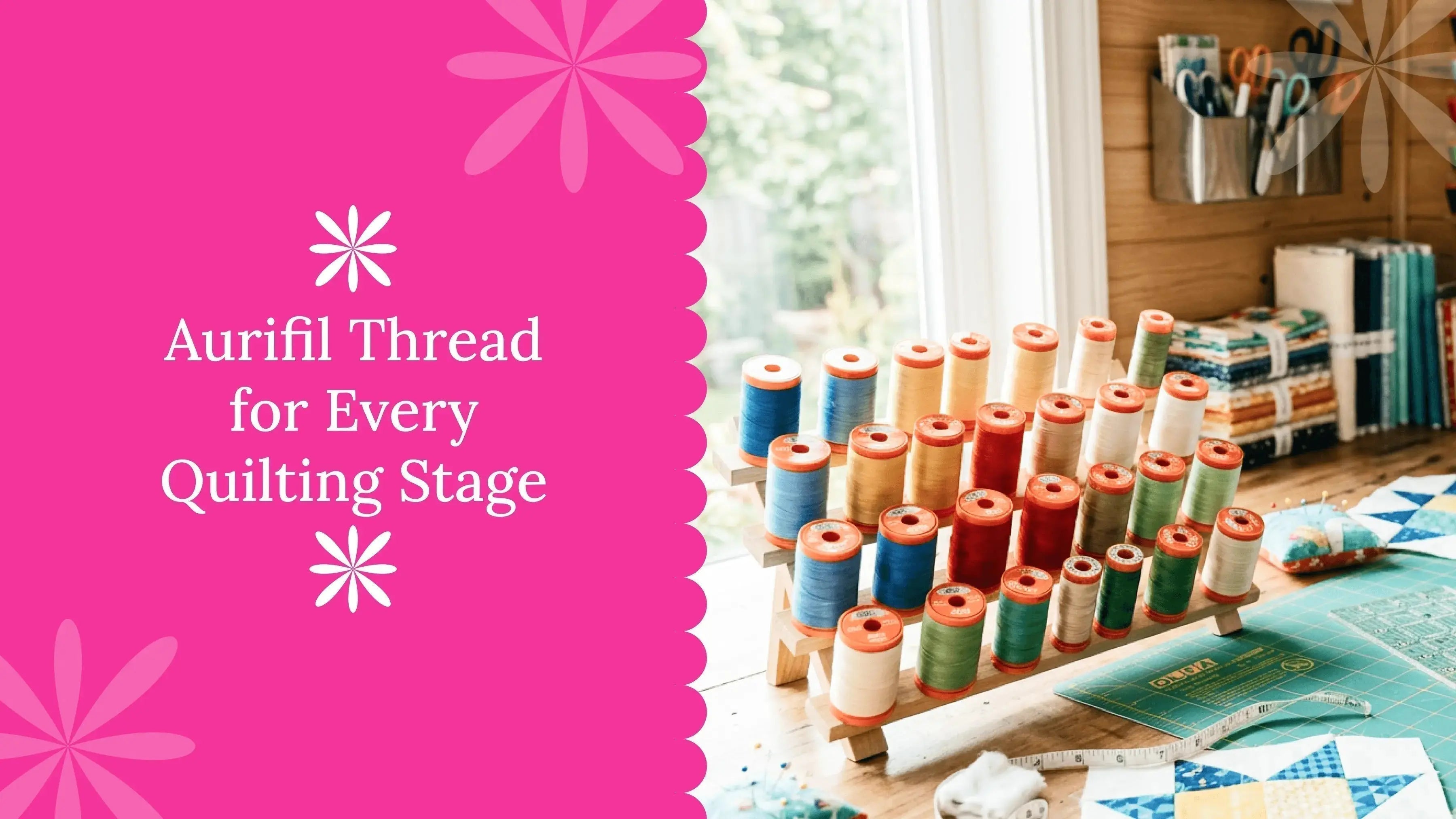Aurifil quilting thread with quilt blocks and quilting tools on a sewing table