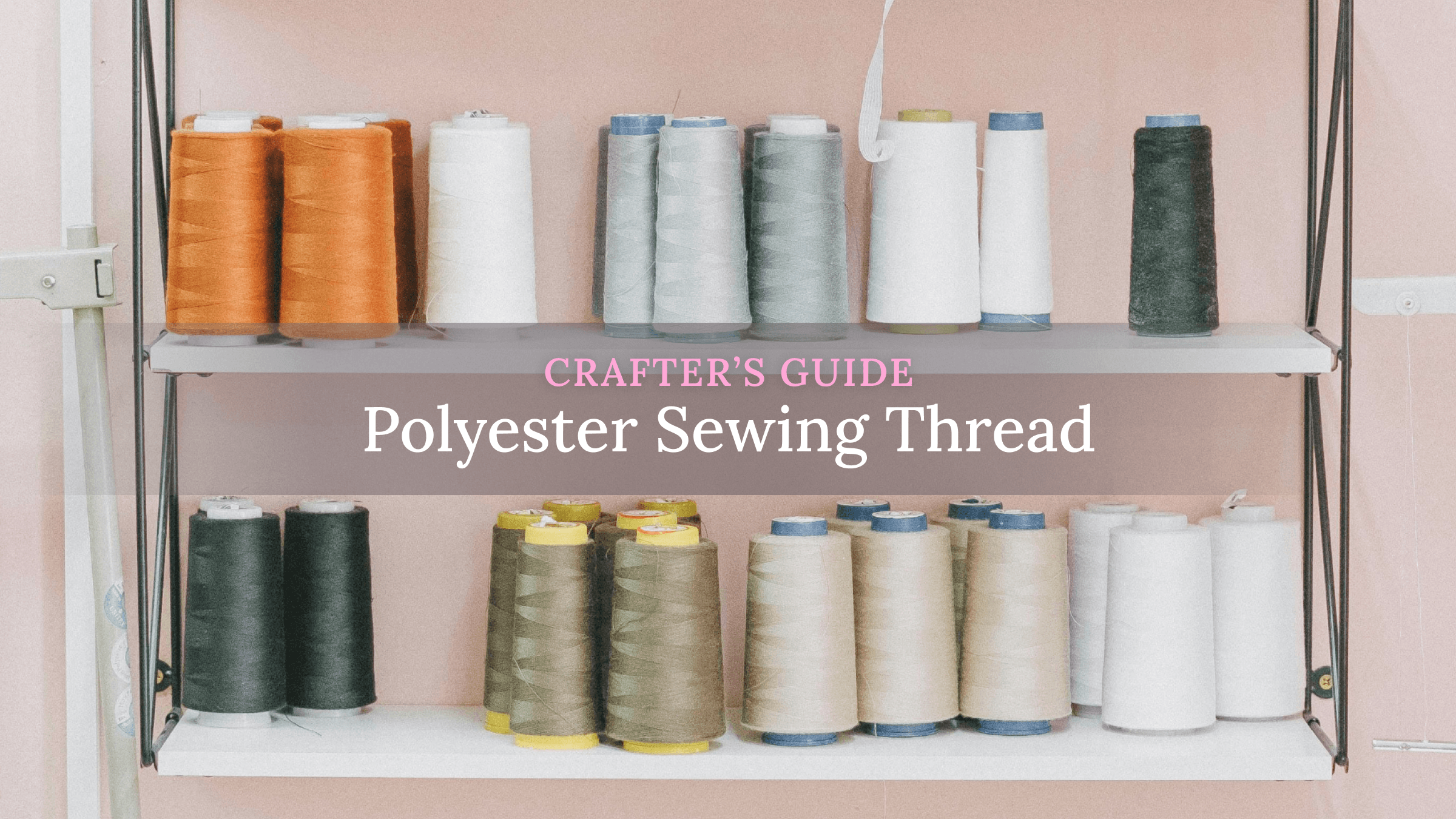 colorful polyester sewing thread spools beside sewing machine and fabric