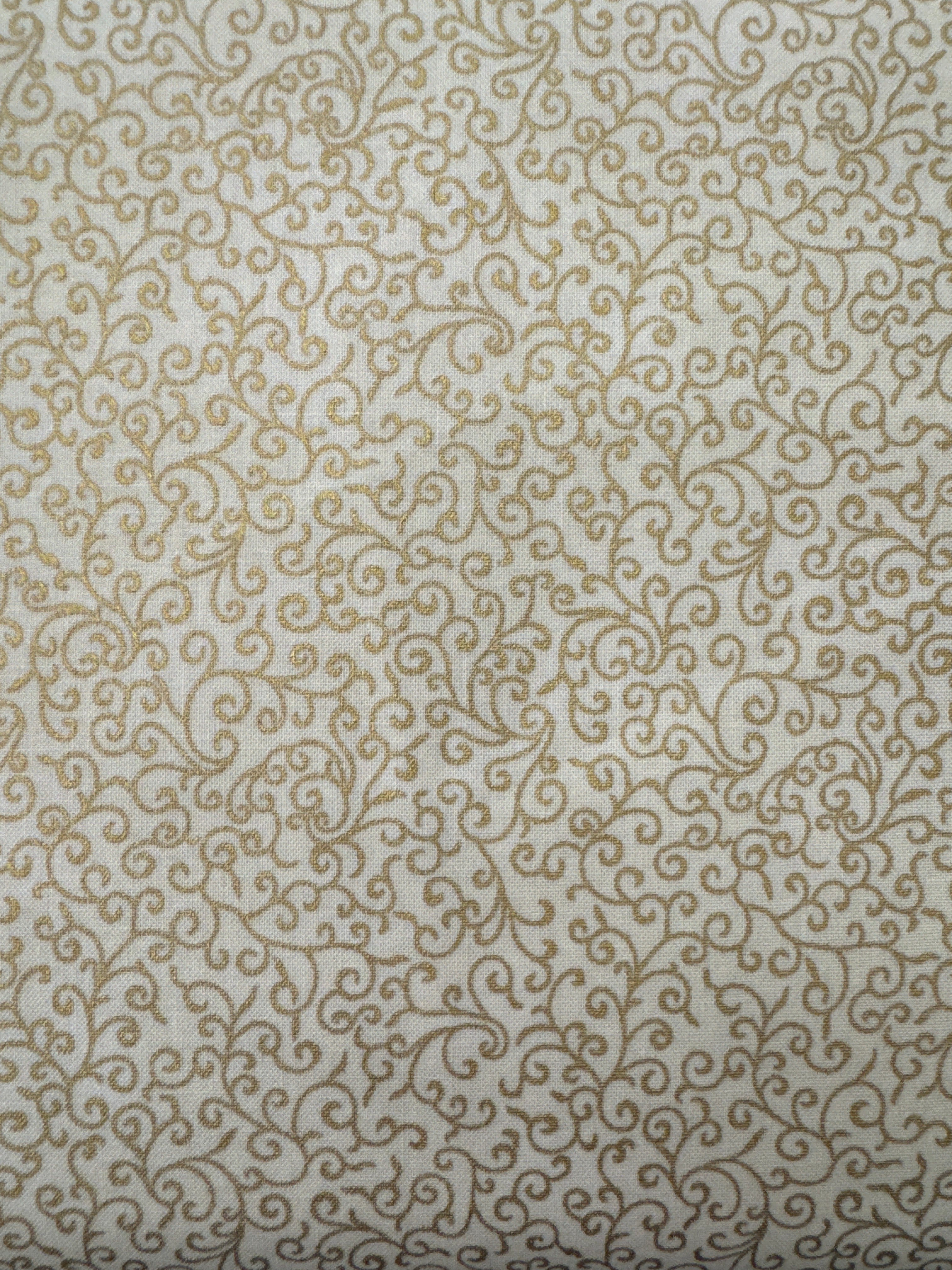Gold Swirly on Cream blender quilting fabric by Hoffman