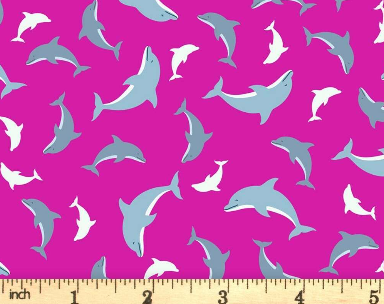Ocean Glow Pink Dolphins glow in the dark novelty quilting fabric by Lewis and Irene