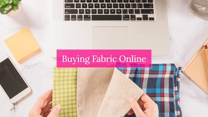 Fabric swatches laid out next to a laptop for online fabric shopping