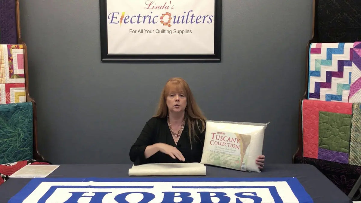 Stephanie Hackney of Hobbs Bonded Fibers holding a sample of Tuscany Silk batting